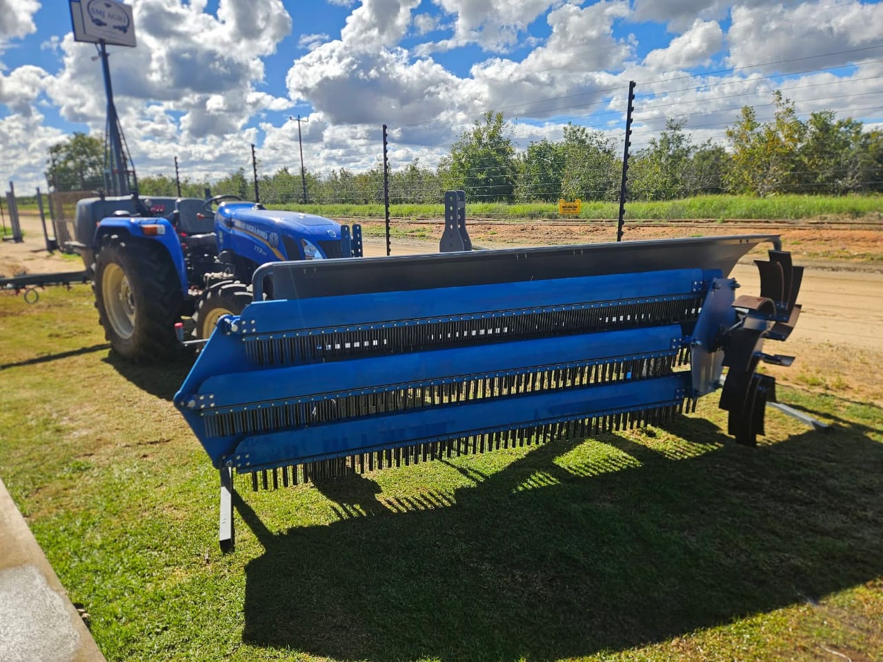 SMJ 3m Orchard Sweeper hitched to a tractor beside a pecan orchard